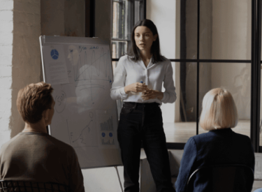 Several people in a meeting, representing discussions and planning for the Food and Hotel Asia (FHA) 2023 event in Singapore